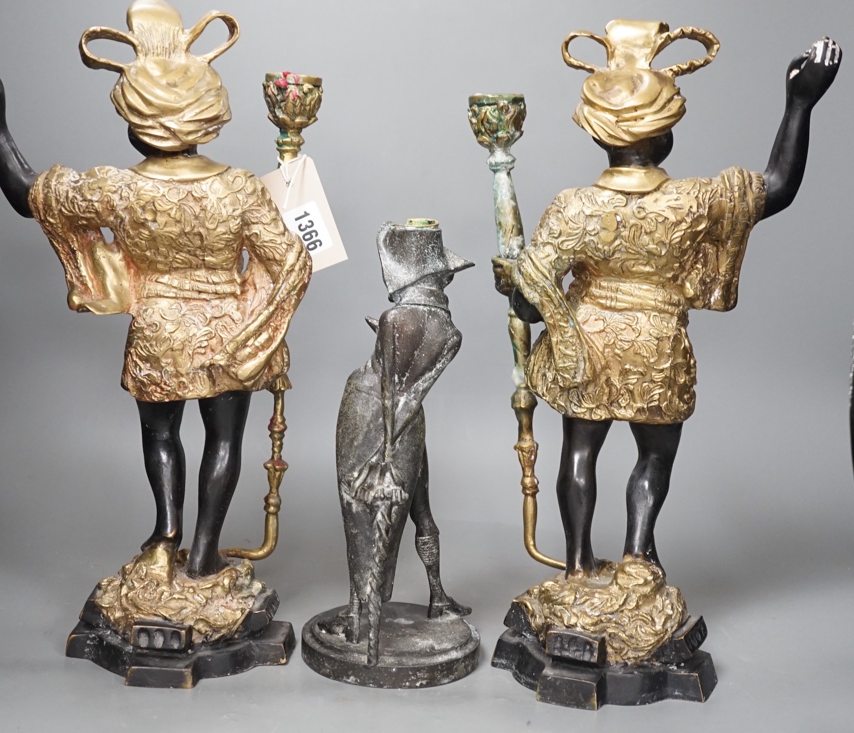 A pair of bronze blackamoor candlesticks and one other spelter figural candlestick, tallest 39cm